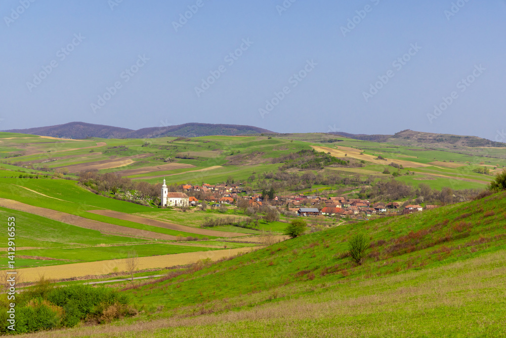 Landscape of a village in a hilly area in Romania seen from a distance