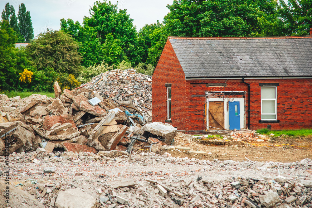 Fototapeta premium Old building site shows demolished structure with rubble and debris