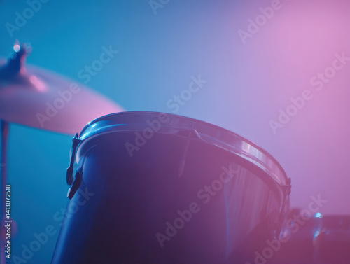 Moody lighting highlights cinematic drum kit with soft, atmospheric glow