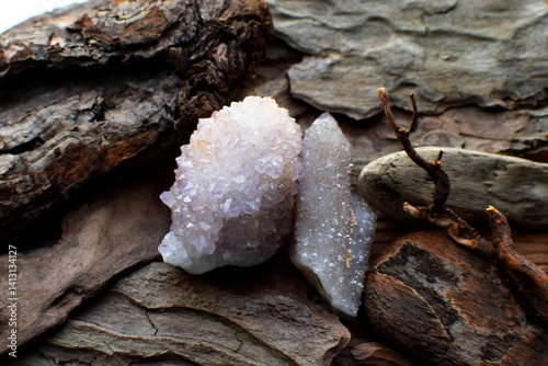 Beautiful pink crystals of amethyst quartz on a wooden background. Cactus quartz, known as spirit quartz.