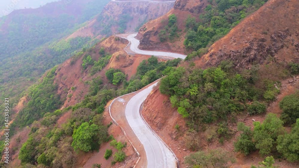 Aerial view winding track on rugged mountain Aerial view winding track on rugged mountain
