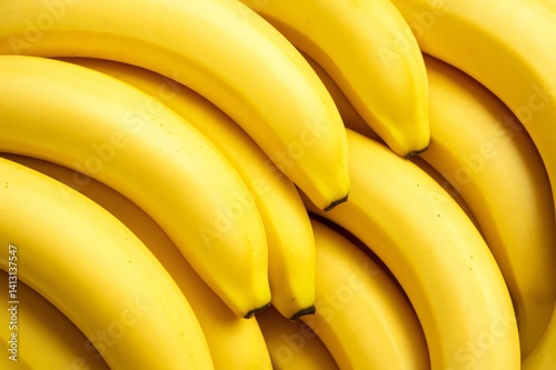 Ripe yellow bananas showcasing smooth skin, clustered together with natural golden hue and uniform curvature