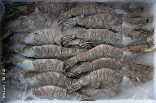 A box of frozen raw shrimps.