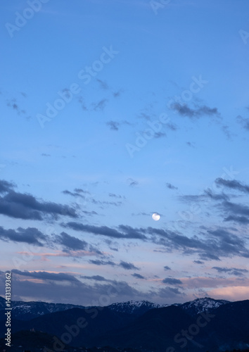 Full moon over mountains.