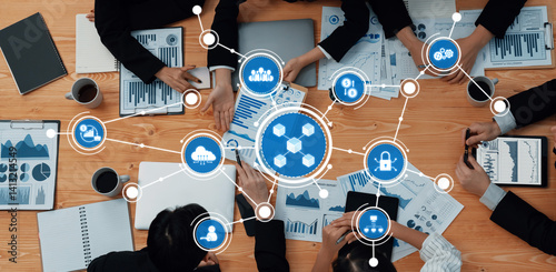 Obraz na płótnie A dynamic business meeting showcasing collaboration over data charts and technology symbols, highlighting teamwork and strategic planning in a professional environment. Amity w salonie
