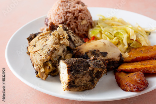 A closeup view of a plate of jerk chicken.
