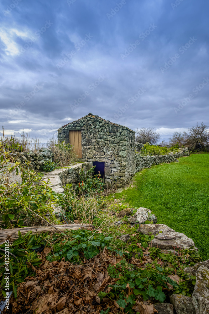Rustic Stone House in Azorean Countryside: Traditional Building in a Lush Green Field, Sao Jorge, Azores, Portugal. Charming Rural Architecture