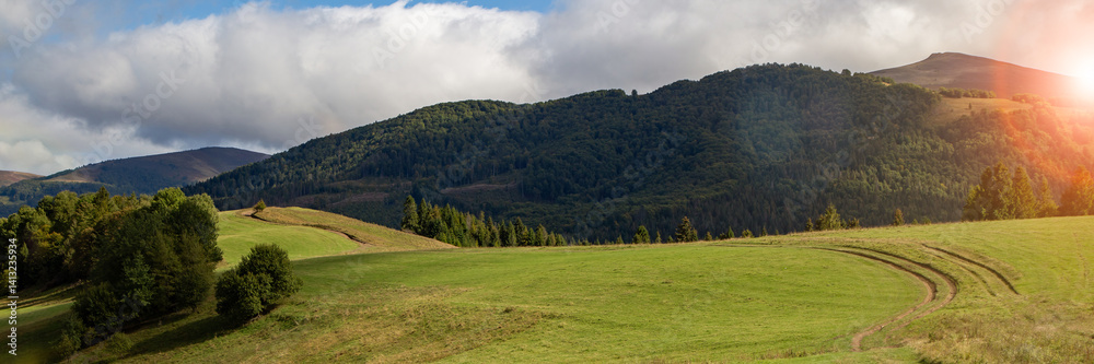 Beautiful landscape view of rolling hills and lush greenery during golden hour in a serene countryside setting