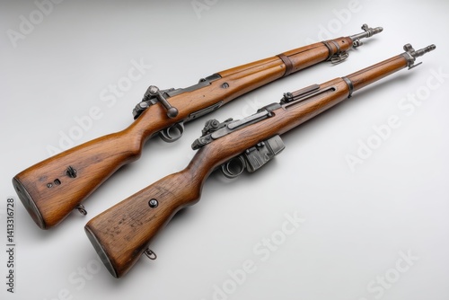 Two vintage World War II era rifles, German Kar98k and US M1903 Springfield, classic firearms of the 20th century, on a neutral background, showing historical arms