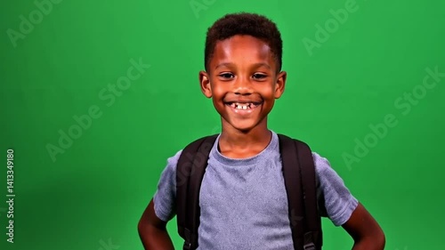 Backpack Portrait Smiling boy with a backpack against a green screen.