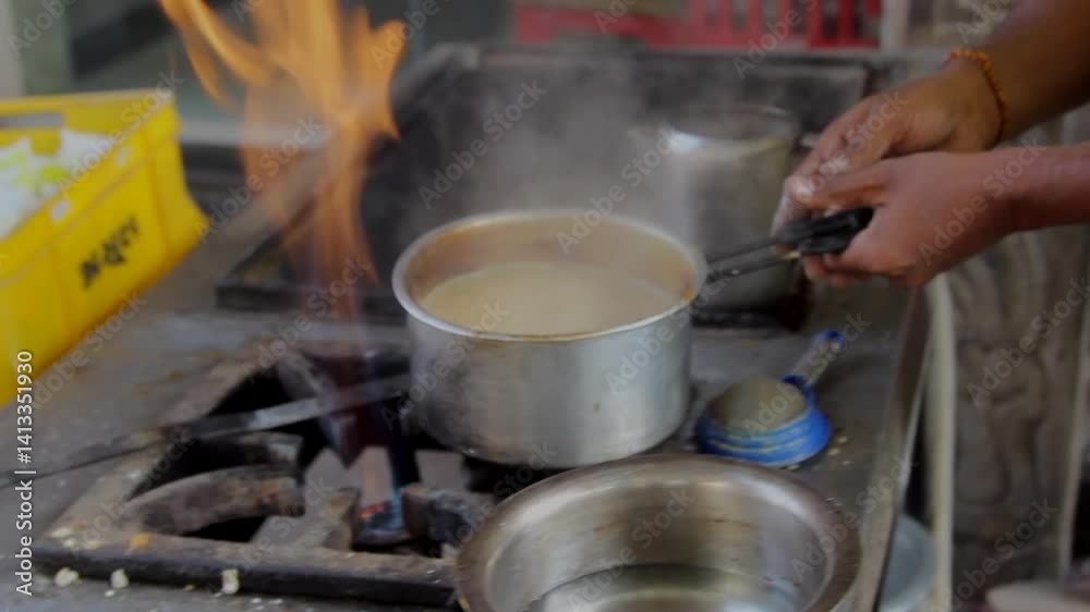 An Indian man prepares masala tea on the street of Mumbai. An Indian man prepares masala tea on the street of Mumbai.