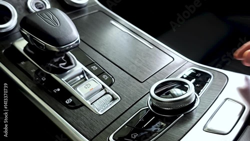 Close-up hands man sitting in driver seat changing gear from P gear to R gear using modern rotary knob located on center console, showcasing advanced technology and design.