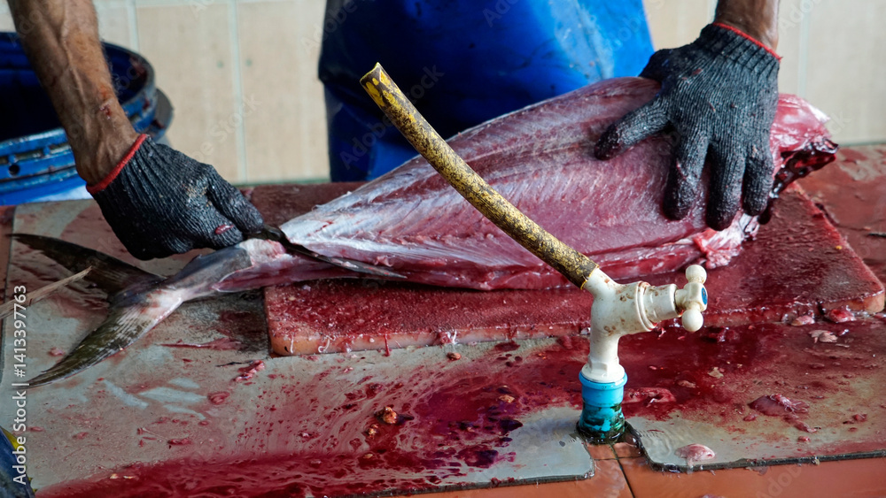 preparing fresh tuna steak at the fish market
