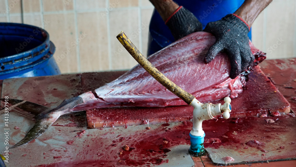 preparing fresh tuna steak at the fish market