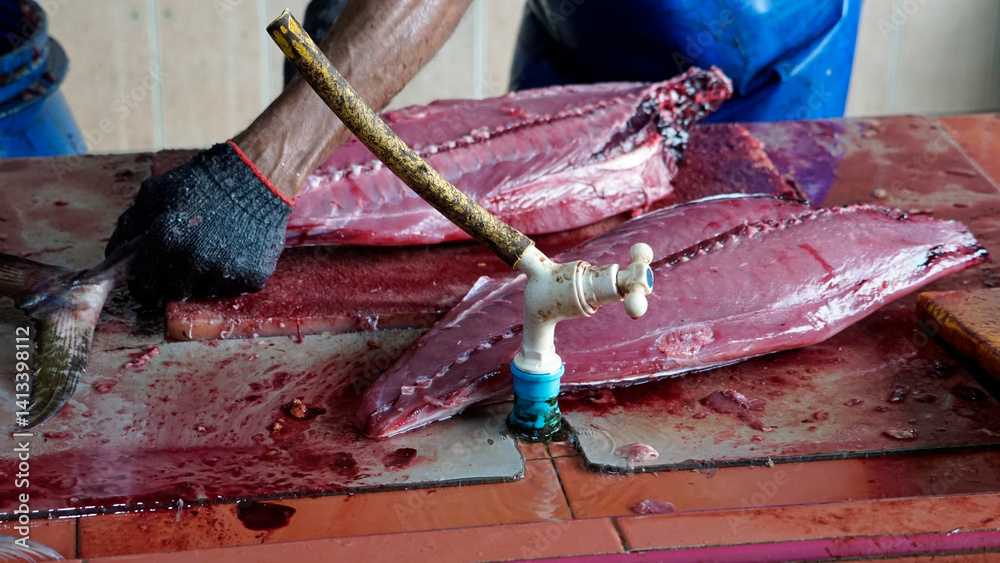 preparing fresh tuna steak at the fish market