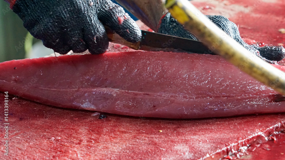 preparing fresh tuna steak at the fish market