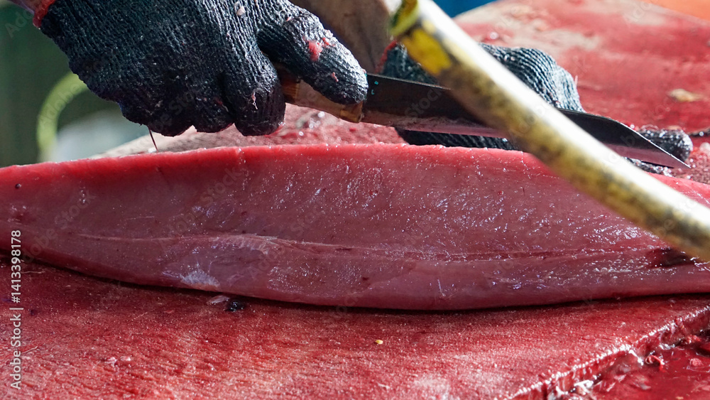 preparing fresh tuna steak at the fish market