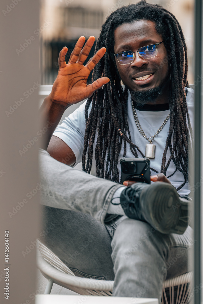 young african man waving with cell phone