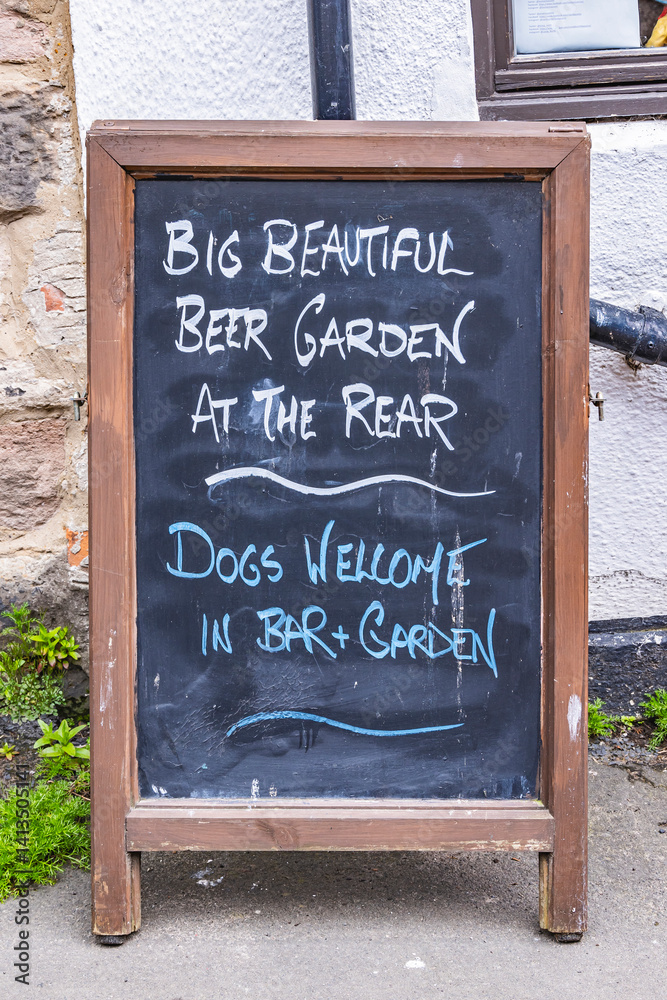 Fototapeta premium Lindisfarne, Holy Island, Berwick-upon-Tweed, Northumberland, England. Chalkboard sign outside pub.