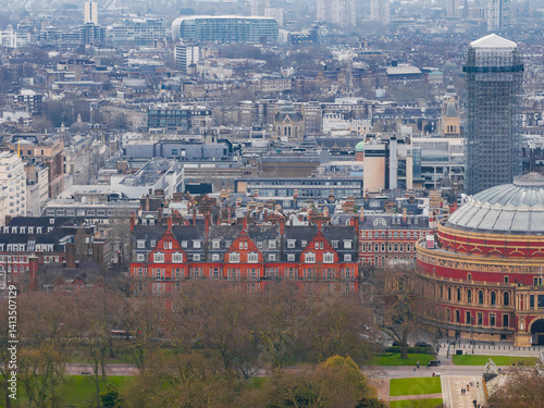 Obraz na płótnie Aerial view of London with the Royal Albert Hall on the right, bare trees in the foreground, red brick buildings, and modern high rises in the distance. w salonie
