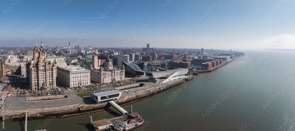 Aerial view of Liverpool showcasing the Royal Liver Building, Cunard Building, Port of Liverpool Building, Museum of Liverpool, and the Mersey River.