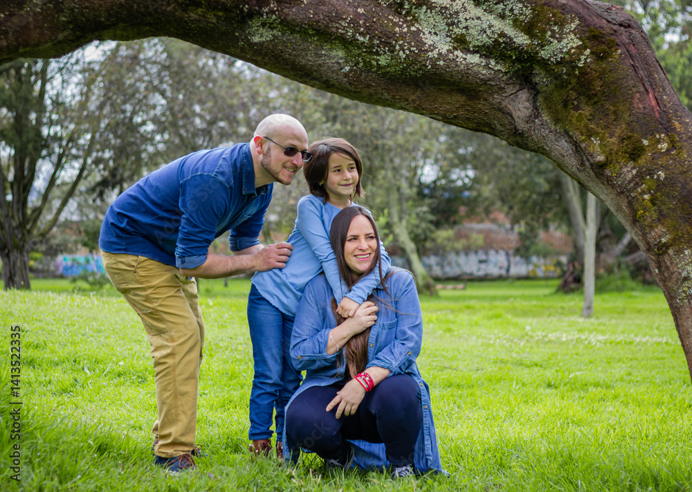 Family under a sprawling tree share a tender, caring moment. Their features evoke unity, warmth, and heartfelt connection in nature. Family under a sprawling tree share a tender, caring moment. Their features evoke unity, warmth, and heartfelt connection in nature.