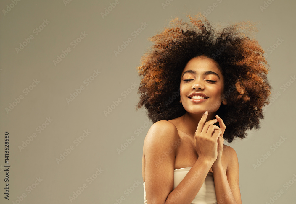 Beautiful dark-skinned curly-haired girl with closed eyes and hands near her face. Beautiful dark-skinned curly-haired girl with closed eyes and hands near her face.