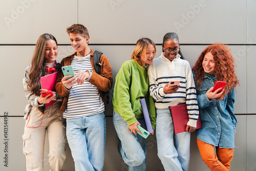 Group of cheerful teens using their smartphones while enjoying together, sharing on the social media as they communicate through various applications and features on their mobile phone photo
