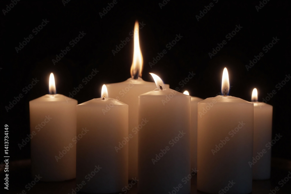 group of white candles sitting on top of a table group of white candles sitting on top of a table