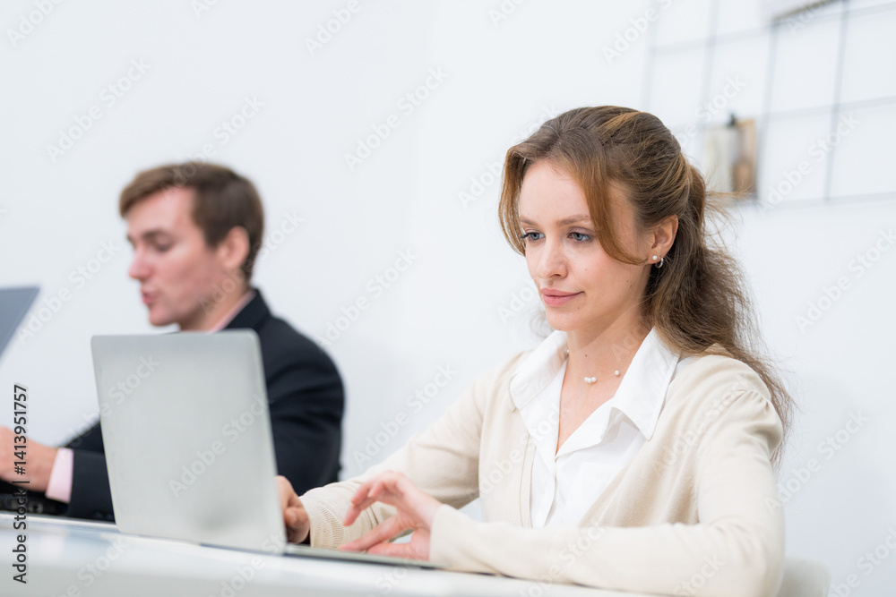 Individuals working diligently at a modern co-working space during the day Individuals working diligently at a modern co-working space during the day