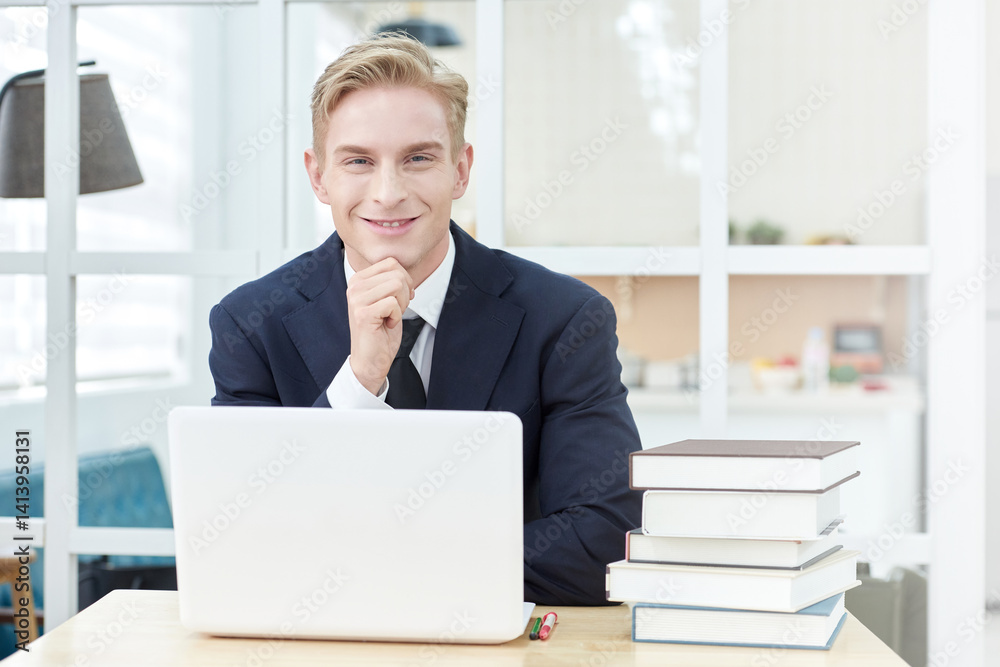 Successful Businessman Celebrating Achievement at Office Desk Successful Businessman Celebrating Achievement at Office Desk
