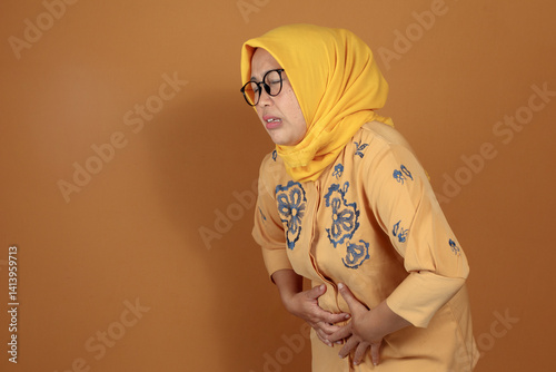 Woman holding stomach in pain expression showing health discomfort issue
