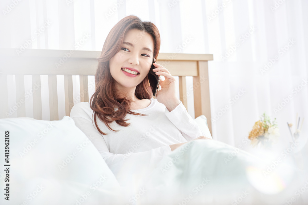 Woman Talking on Phone in Bed, Bright Morning Woman Talking on Phone in Bed, Bright Morning