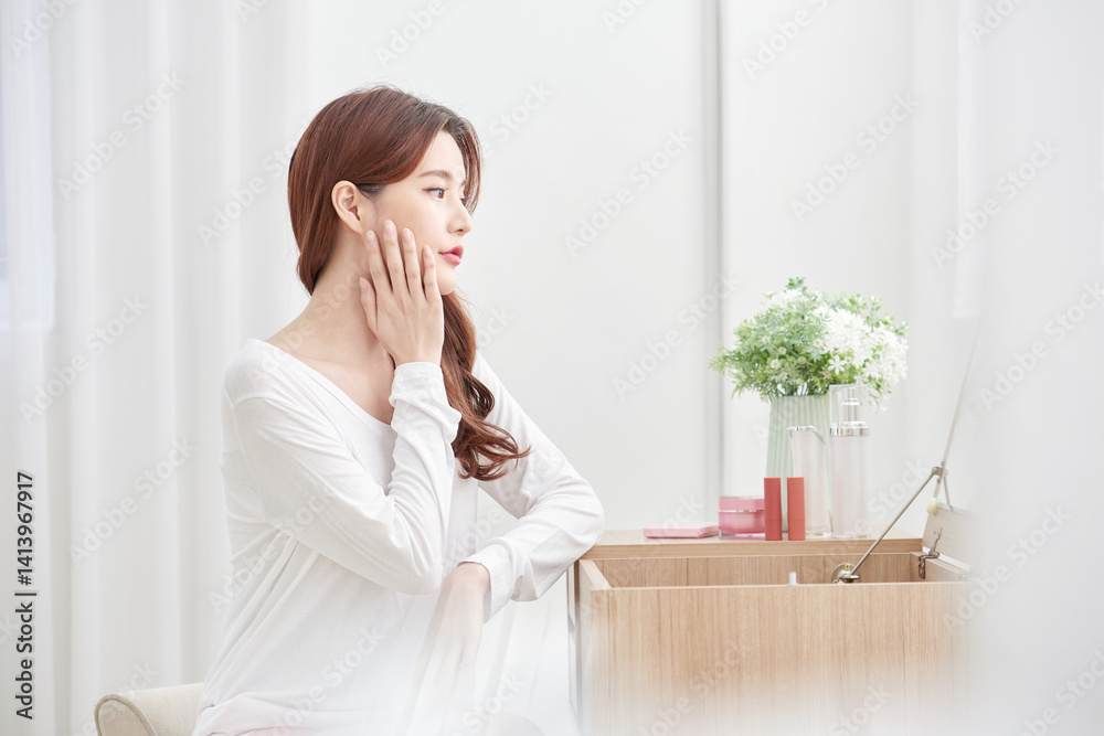 Woman Sitting at Vanity Table in Bright Room Woman Sitting at Vanity Table in Bright Room