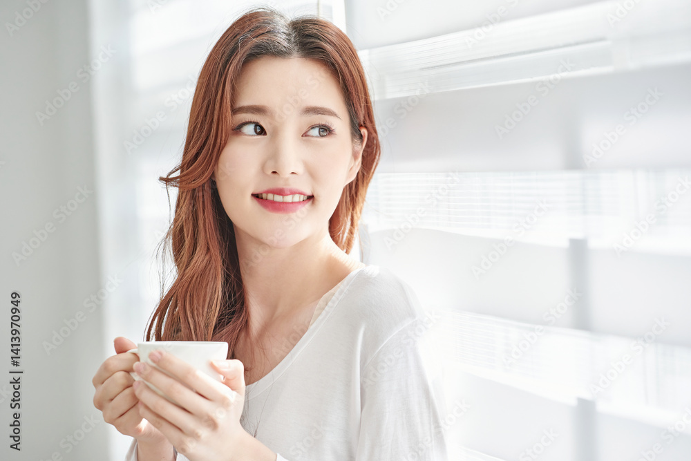 Young Woman Smiling with Coffee Cup Indoors Young Woman Smiling with Coffee Cup Indoors
