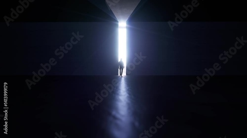 A person walks towards a ray of light in a dark place