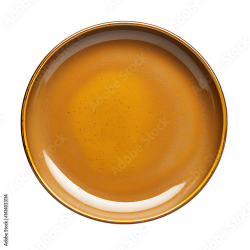 Obraz na płótnie Round ceramic dinner plate with a warm ochre glaze and natural speckled finish captured from above in a clean and detailed look on a transparent background w salonie