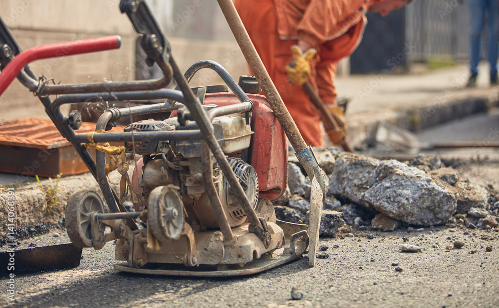 Construction worker working on a public city road reconstruction