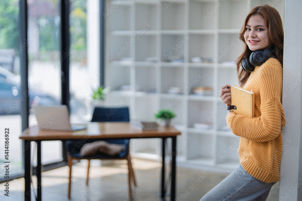 happy young woman with headphones is immersed in a book, happily learning happy young woman with headphones is immersed in a book, happily learning
