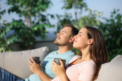 Couple relaxing and drinking in a terrace
