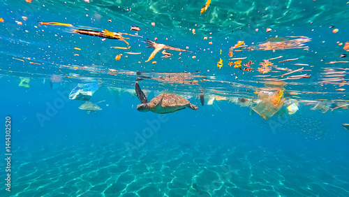 Underwater view of sea turtles swimming in ocean plastic pollution debris floating on surface of water