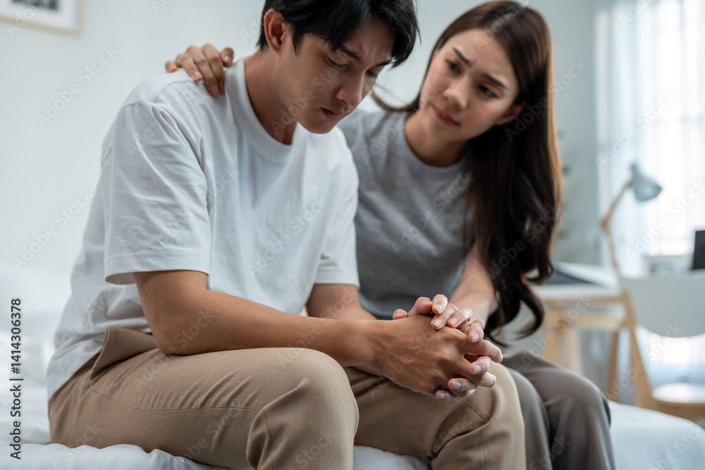 Obraz premium Asian wife comforting her husband crying with tears for life problem.