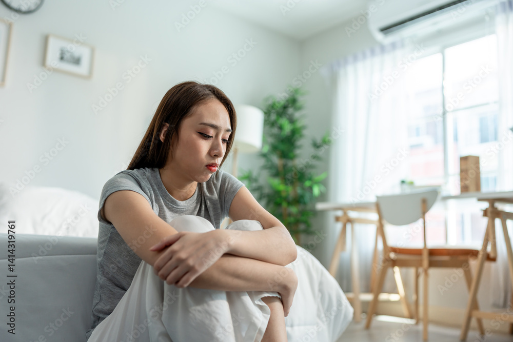 Depressed Asian woman feel upset while sitting alone on floor in bedroom. Depressed Asian woman feel upset while sitting alone on floor in bedroom.