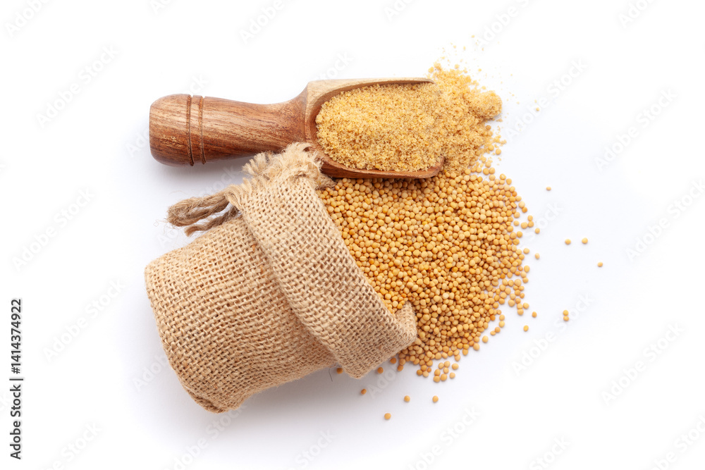 Ταπετσαρία A scoop of organic Yellow Mustard seeds (Sinapis alba) powder, along with whole mustard seeds spilled out from a jute bag