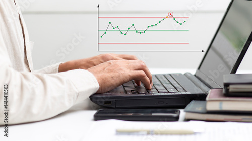 Process engineer work with laptop with analyze graph data out of control at workplace in office, process development and improvement concept
