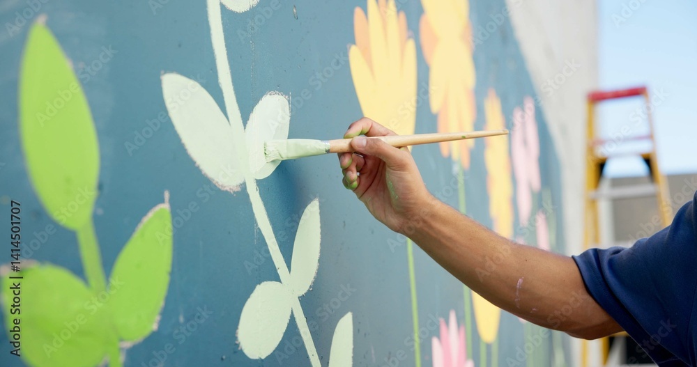 Man, hand and painting in city for wall art, creative mural and project to uplift community. Volunteer, creativity and outdoor with equipment for floral decor, social responsibility and DIY hobby