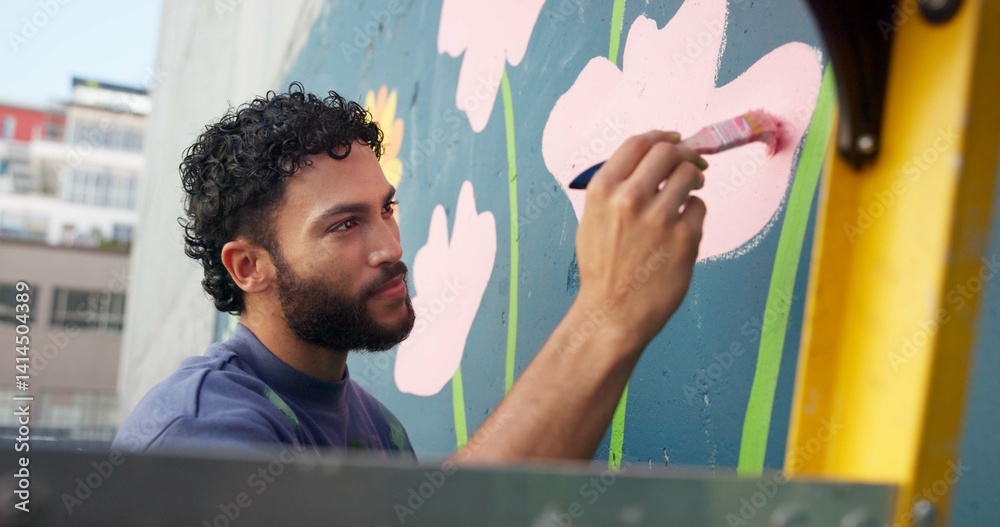 Man, painting and design in city at wall art, creative mural and project to uplift community. Volunteer, creativity and outdoor with smile for floral decor, social responsibility and DIY hobby