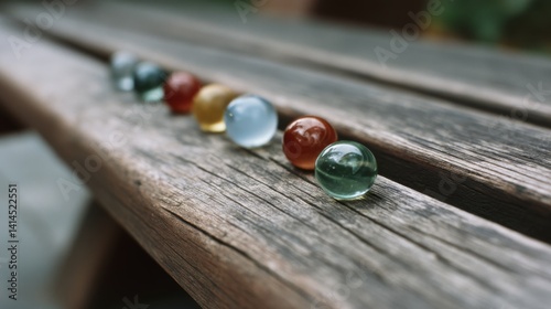 Obraz na płótnie Colorful glass marbles rest gracefully on rustic wood, evoking childhood nostalgia and simple pleasures. w salonie