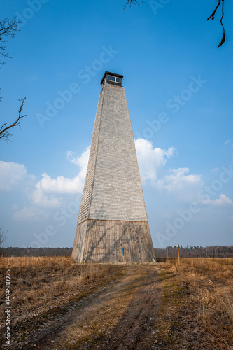 Fire lookout tower n the field is covered with wood chips. A fine example of the 19th century. Verenes fire watch tower, Latvia.