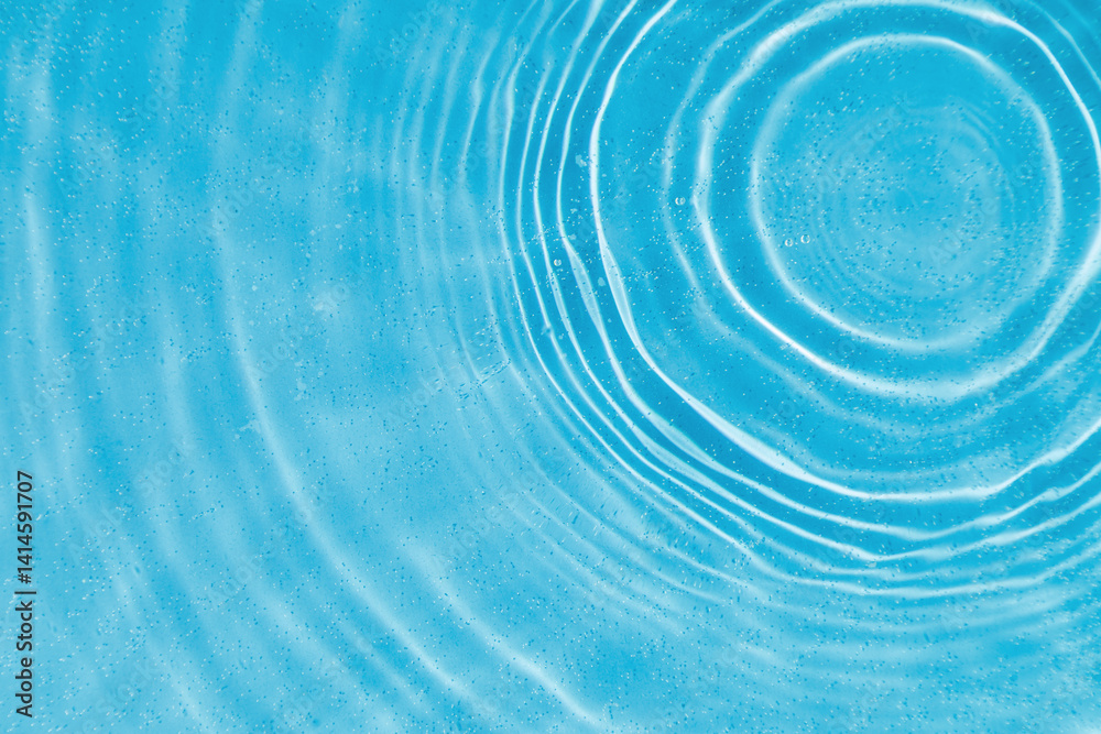 drops on water with circles on a blue background